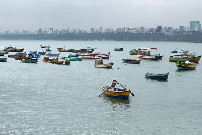 Lima Off the Beaten Path: Local Communities and Cultural Immersion - Chorrillos, fishing boats beside the city skyline